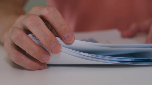 istock man hand checking or working with paperwork business report or documents 1967410278