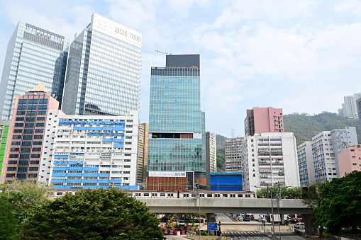 MTR Train Approaching kwai hing Station and industrial buildings in Hong Kong - 01/27/2024 14:06:23 +0000.