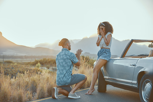 Love, propose or couple on outdoor road trip on holiday together with ring, surprise or care. Asking, wow or people in countryside with shock or one knee on vacation for romance and valentines day