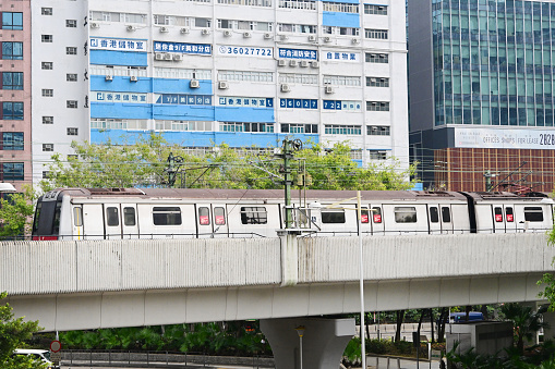 MTR Train Approaching kwai hing Station and industrial buildings in Hong Kong - 01/27/2024 14:12:17 +0000.