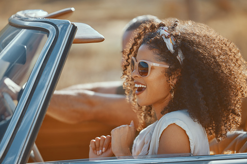 Car, happy woman or couple on road trip on holiday together with love, care or adventure. Excited, interracial or people in countryside, convertible or transport for vacation for freedom or honeymoon