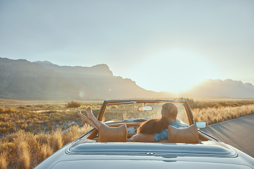 View, relax or couple in countryside road trip on holiday together for love, romance or adventure. Calm, back or people in convertible car or transport on vacation for mountains, peace or honeymoon