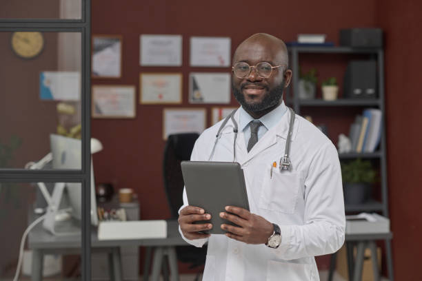 istock Professional Black Physician Posing at His Workplace 1967449504