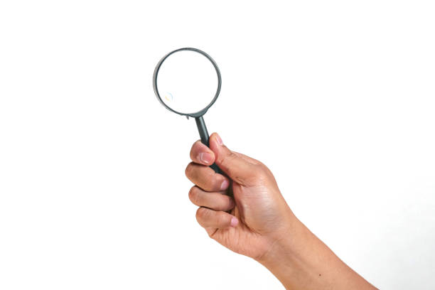 istock hand holding magnifying glass Isolated on white background 1967514367