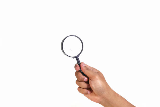 hand holding magnifying glass Isolated on white background