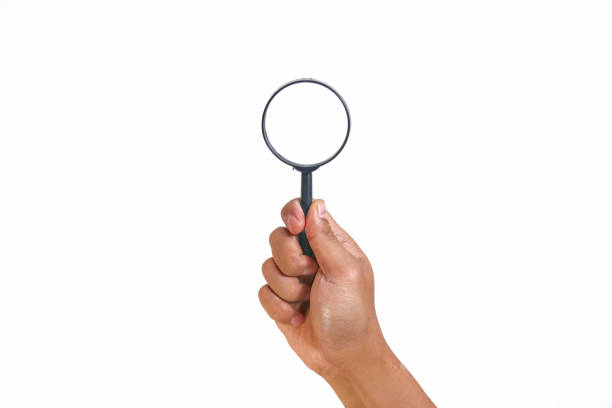 istock hand holding magnifying glass Isolated on white background 1967515962