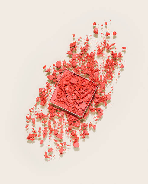 istock Red colored broken swatch of eye shadow powder or blusher on beige background, aesthetic flat lay, crumbling face makeup powder, woman cosmetics and beauty product, eyeshadows powder texture 1967522782