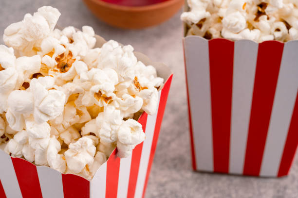 popcorn in red and white striped paper box isolated on vintage background - large cheese beautiful red zdjęcia i obrazy z banku zdjęć