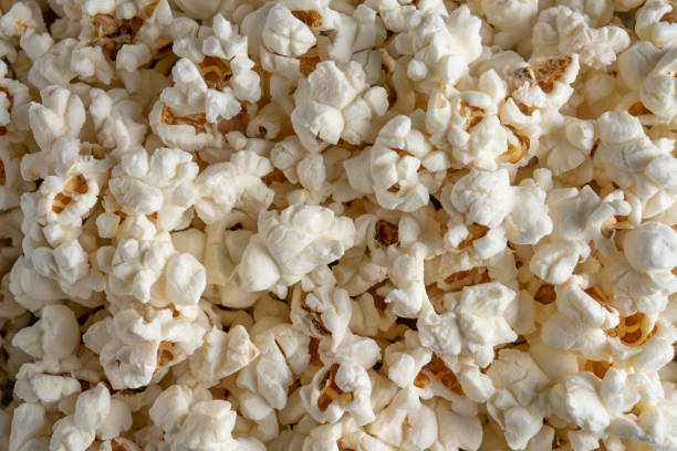 istock Popcorn in red and white striped paper box isolated on vintage background 1967535185