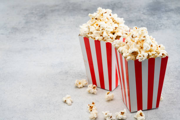 popcorn in red and white striped paper box isolated on vintage background - large cheese beautiful red zdjęcia i obrazy z banku zdjęć