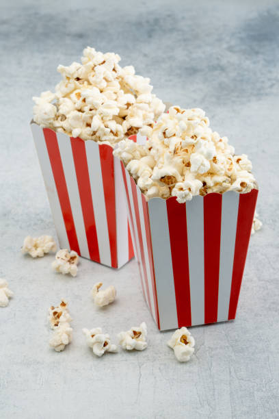 popcorn in red and white striped paper box isolated on vintage background - large cheese beautiful red zdjęcia i obrazy z banku zdjęć