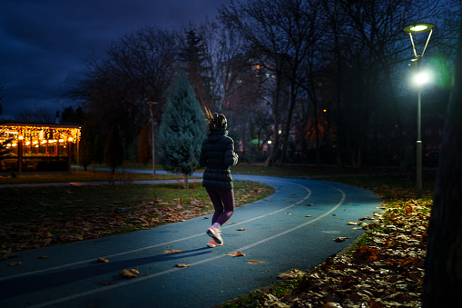 Part of a series of a woman doing exercises in a public park during winter.