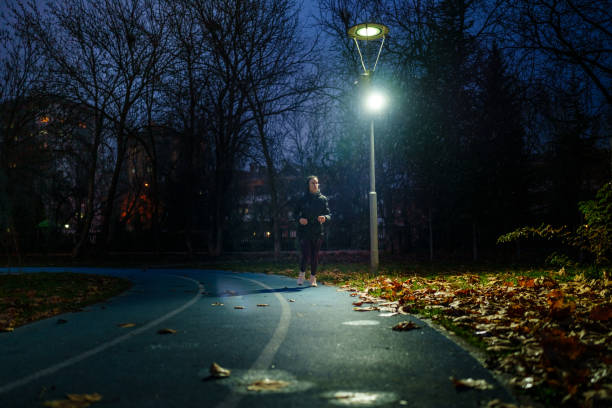 istock Running under the rain in running track 1967536012