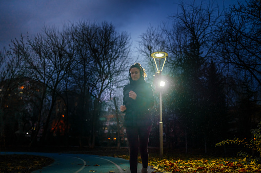 Part of a series of a woman doing exercises in a public park during winter.