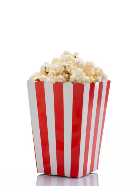 istock Popcorn in red and white striped paper box isolated on white background 1967536243