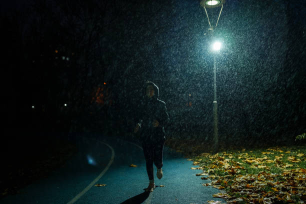 istock Running under the rain in running track 1967539198