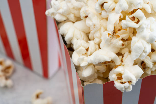 popcorn in red and white striped paper box isolated on vintage background - large cheese beautiful red ストックフォトと画像