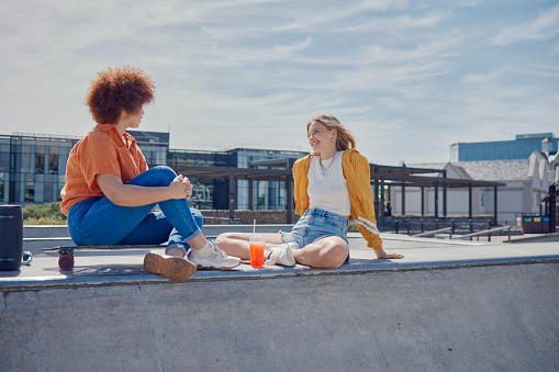 Close up of mom and daughter embracing on a park bench.