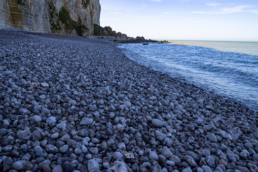 Low angle view of round pebbles on the beach in normandy, france