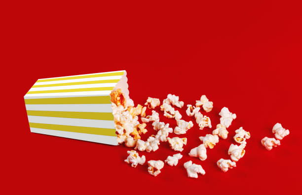 istock box with popcorn striped in different colors on a red background 1967541385