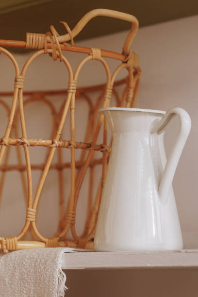 istock White enamel jug beside woven basket 1967543433