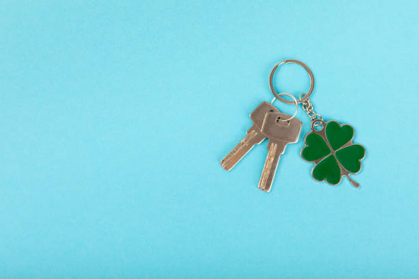 istock Keychain with key ring isolated on a colored background. Concepts for real estate and moving home or renting property. Buying a property. Mock-up keychain.Copy space. 1967556863