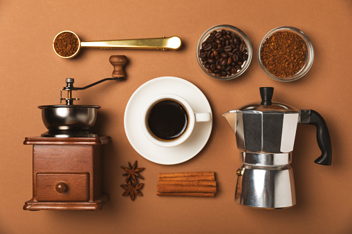 Ingredients for making coffee. Different ways to make coffee geyser moka maker,turkish coffee pots (cezve). Coffee making concept with milk, cinnamon and star anise. Flat Lay. Top view. Copy space