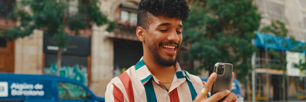 istock Young man taking photo on cellphone on summer day outdoors, Panorama 1967568139
