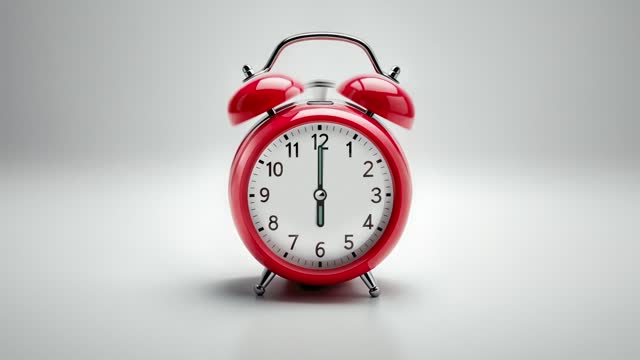 Alarm clock ringing at 6 o'clock. It's ticking quickly  on a white background in the studio lights. The concepts of speed, time, deadline, waking up, stress, bell rings, hour, time lapse, schedule, calendar date, finalize, retro style