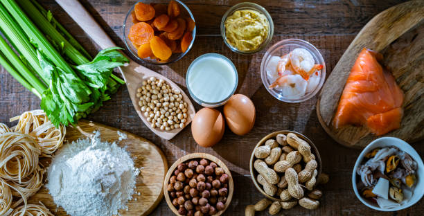Composition with common food allergens Composition with common food allergens including egg, milk, soya, nuts, fish, seafood, wheat flour, mustard, dried apricots and celery mustard fruits stock pictures, royalty-free photos & images