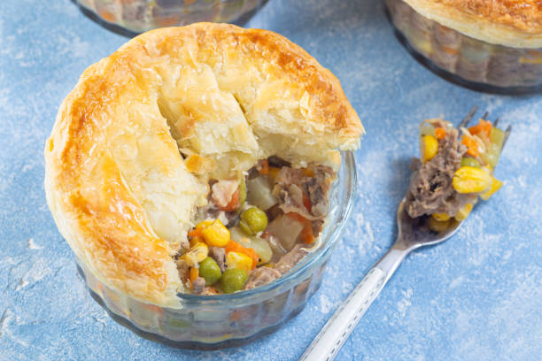 istock Individual beef pot pie or deep dish pie in ramekin, crust broken open to show inside, horizontal 1967633951