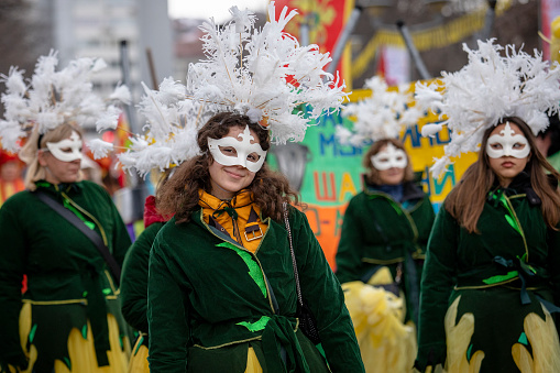 Pernik, Bulgaria - January 27, 2024: 30th anniversary Masquerade festival in Pernik Bulgaria. Women dressed in national costumes dance and perform a fertility and health ritual.