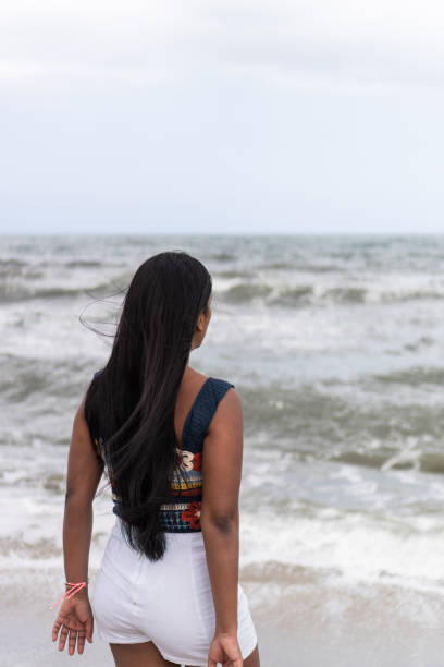 istock Latin Woman Contemplating Ocean Waves 1967652929