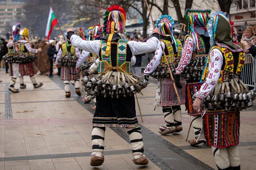 Pernik, Bulgaria - January 27, 2024: 30th anniversary Masquerade festival in Pernik Bulgaria. Men dressed as kukeri dance and perform a ritual for fertility and health.