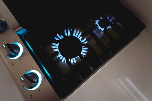 gas kitchen stove with blue flames from above
