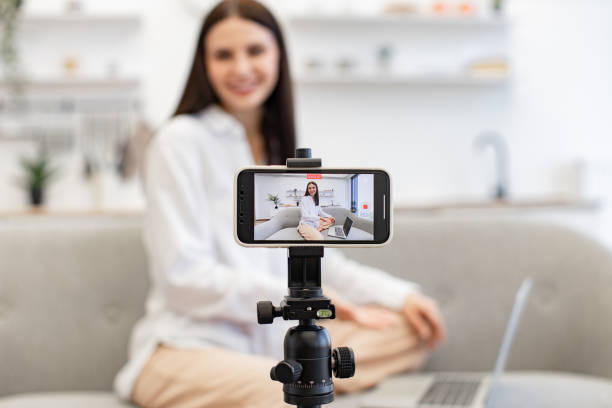 istock Demanding tutor using modern smartphone with tripod for online training. 1967707181