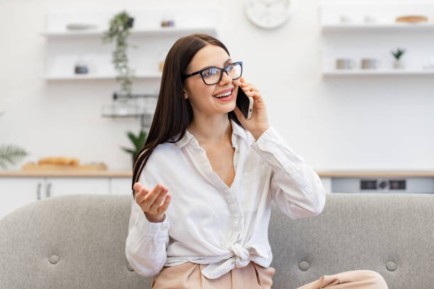 istock Female gesturing while having conversation on smartphone, staying at home. 1967713333