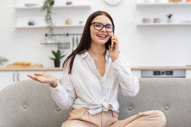 istock Woman enjoying communication with colleagues while sitting on cozy sofa. 1967713341