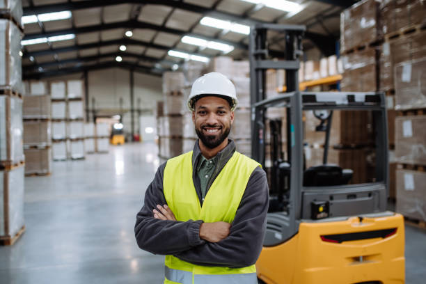 istock Portrait of warehouse worker standing by forklift. Warehouse worker preparing products for shipmennt, delivery, checking stock in warehouse. Banner with copy space. 1967727732