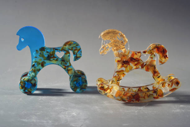 Rocking horse made of precious stones on a gray background close-up