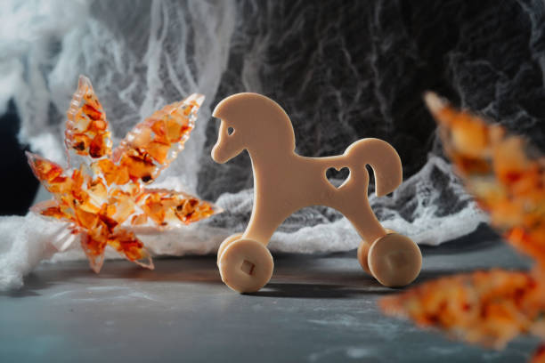 A beautifully crafted wooden rocking horse, adorned with stars and painted details, is a timeless toy, perfect for children.