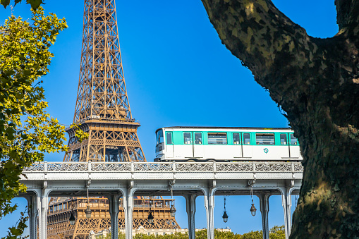 Paris, France - September 09, 2023 : Metro passing over the Bir Hakeim bridge over the Seine in Paris France at Passy station near the Eiffel Tower