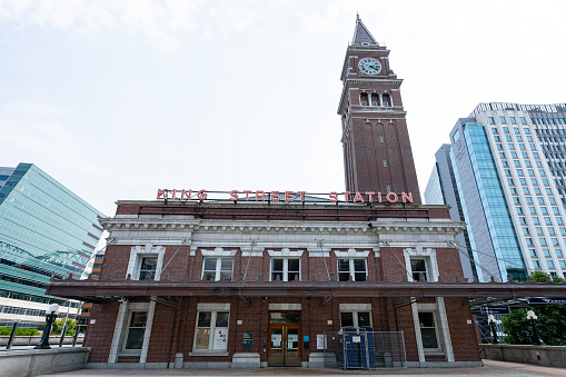 A wide-angle photo of King Street train station in downtown Seattle, Washington with the clock tower towering over.