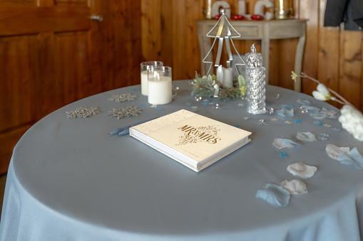 A tasteful guestbook setup at a wedding reception, inviting heartfelt messages.