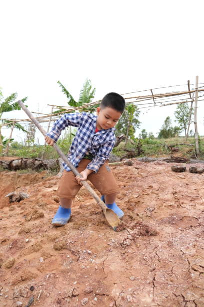 istock Portrait of a boy digging the ground. 1967862724