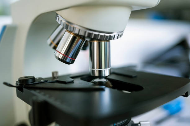 Close-up of a microscope with metal lens at science laboratory