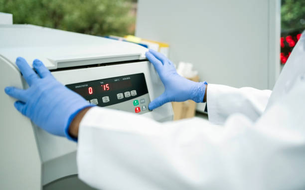 istock Close-up of laboratory assistant hands operating a machine in pathology lab 1967864312