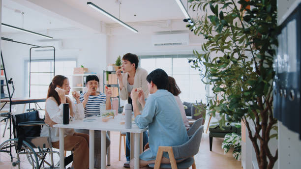 istock Diverse White-Collar Team Bonding: Breaktime Snacks at the Office Workstation 1967865384