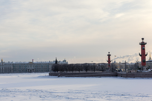 04-01-2024 - St.Petersburg, Russia. White winter landscape with Rostral columns and snow-covered river