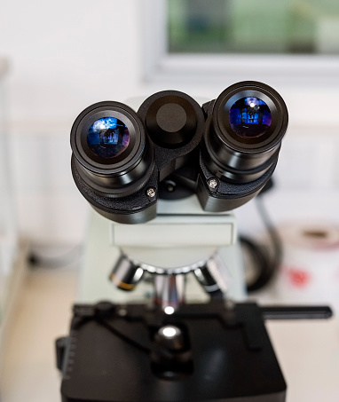 Close-up of microscope eyepiece in pathology lab